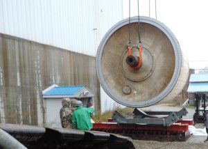 Lowering 156,000 lb., 18’ diameter x 25 long Yankee Dryer from Lincoln, ME tissue mill onto shipping cradles set on sliders. After dryer prepared for shipment, sliders were used to transfer the dryer in its shipping cradles onto trailer for shipment
